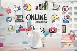 A workspace with a laptop and decor featuring colorful icons representing online marketing concepts like social media, graphs, and creativity.