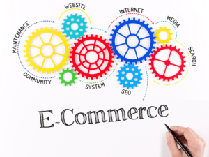 Colorful gears labeled with e-commerce elements like Internet and SEO surround the word "E-Commerce." A hand holds a pen, conveying innovation.