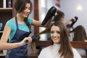 hair salon in the photo one is cutting hair of the another person