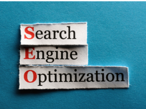 Torn paper strips on a blue background spell "Search Engine Optimization" vertically, with red "S," "E," "O"; bold text conveys emphasis and focus.